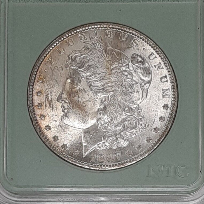 1887 Morgan Silver Dollar Coin BU in Plastic Holder